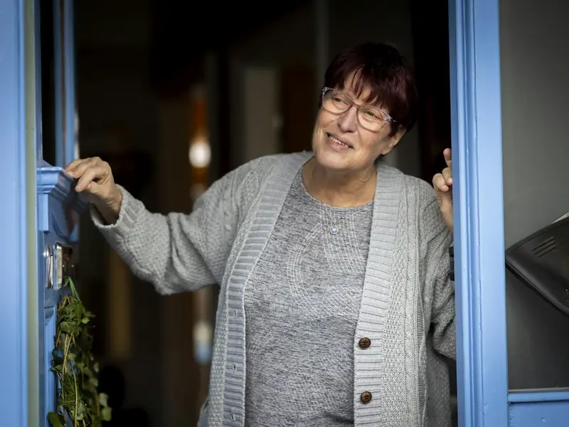 A woman opening her front door